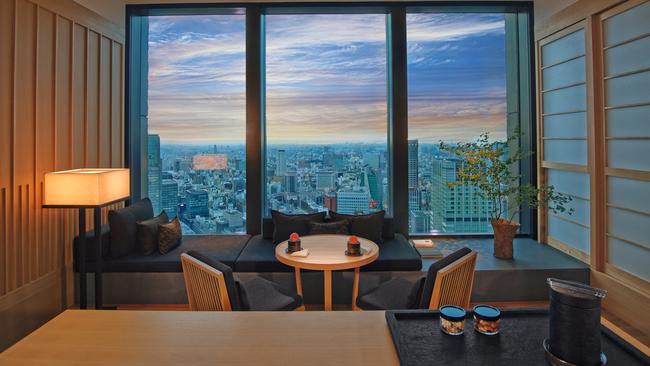 Suite living room with city views at Aman Tokyo.