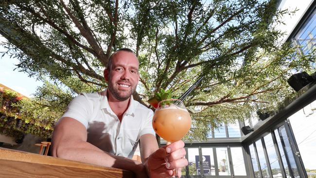 Juju in Nobby Beach, will be opening on Saturday. Owner Trent Redman upstairs enjoying a cocktail under the tree. Picture Glenn Hampson