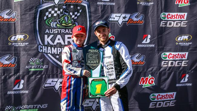 Bundaberg's Ky Burke and Troy Loeskow celebrate winning the national titles in the Cadet 9 and KZ2 class at the final round of the Australian Karting Championship in Melbourne.