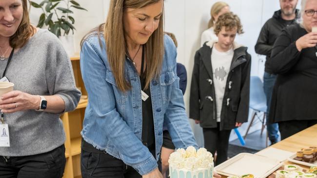 The Babes Project centre manager Annie Buruma cuts the cake at its new base at Croydon's Aquahub.