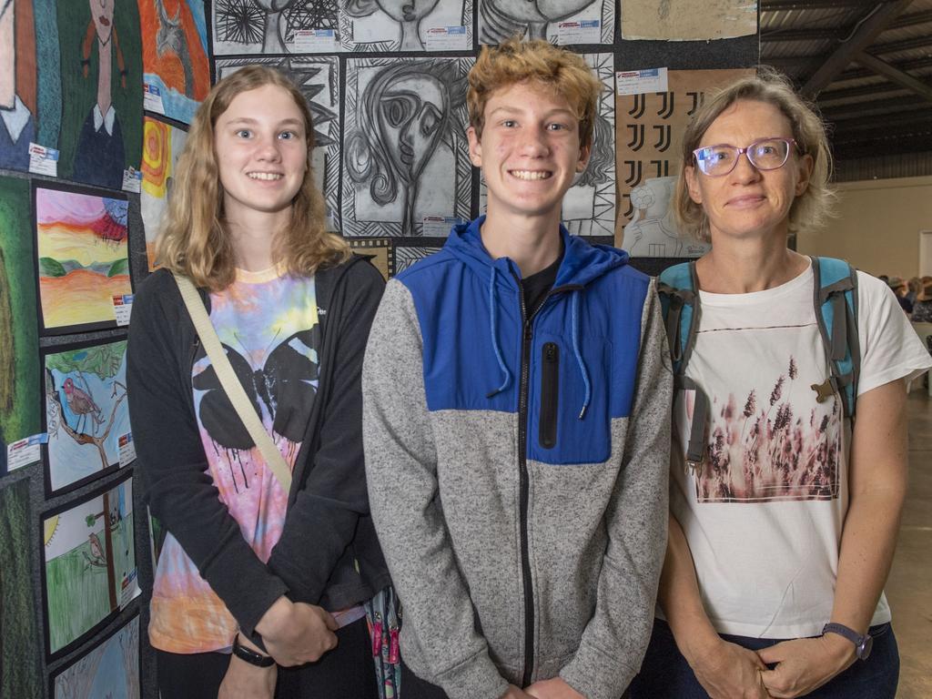 (from left) Lien, Willem and Nele Dekeyser admire the artwork in the pavilion. Toowoomba Royal Show. Saturday, April 1, 2023. Picture: Nev Madsen.