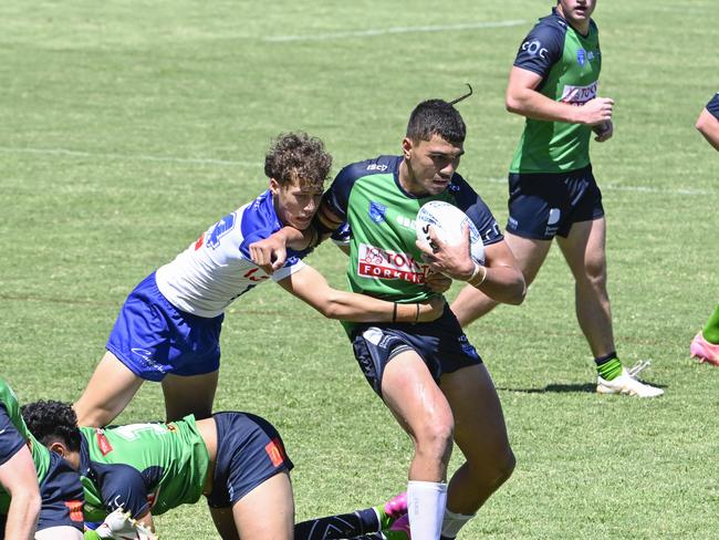 Jezaiah Charles is tackled by Evander Tafua. Picture: Martin Ollman