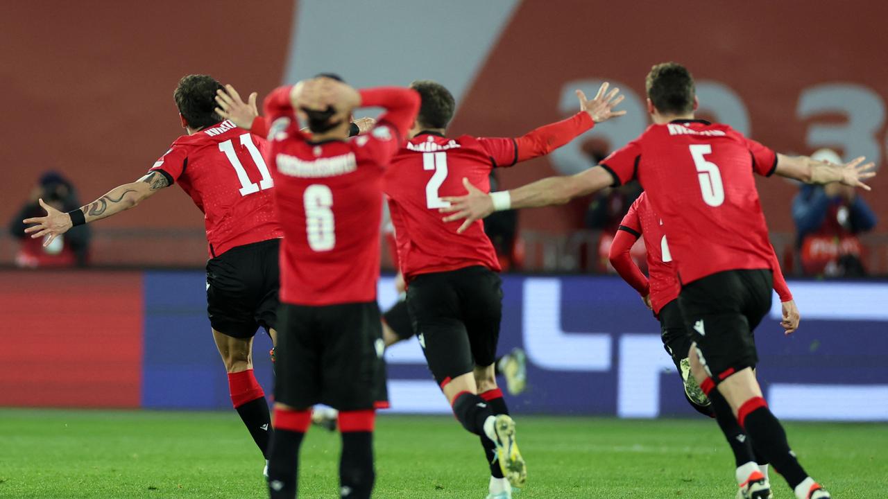 Georgia's players celebrate after winning the UEFA EURO 2024 qualifying play-off final football match between Georgia and Greece in Tbilisi on March 26, 2024. (Photo by Giorgi ARJEVANIDZE / AFP)