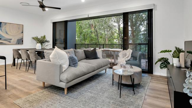 A photo of the kitchen and living area in one of the townhomes at The Orchard in Arana Hills. Image supplied by Tessa Developments.