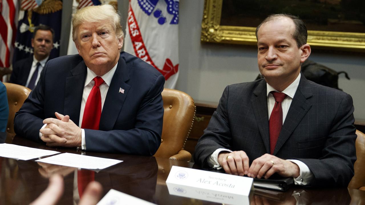 President Donald Trump, left, and Labor Secretary Alexander Acosta listen during a meeting of the President's National Council of the American Worker. Picture: AP/Evan Vucci, File