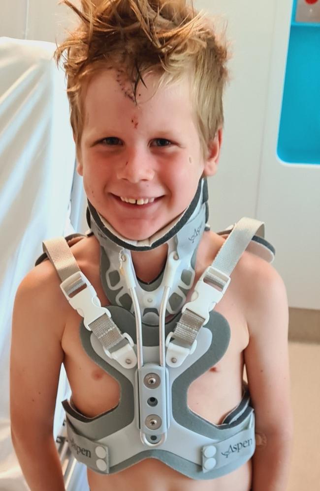 A smiling Daniel now wearing a neck and spinal brace after his fall into the gorge.