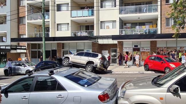 Bystanders at the scene of the accident, where no one was hurt but seven cars were damaged. Picture: Supplied