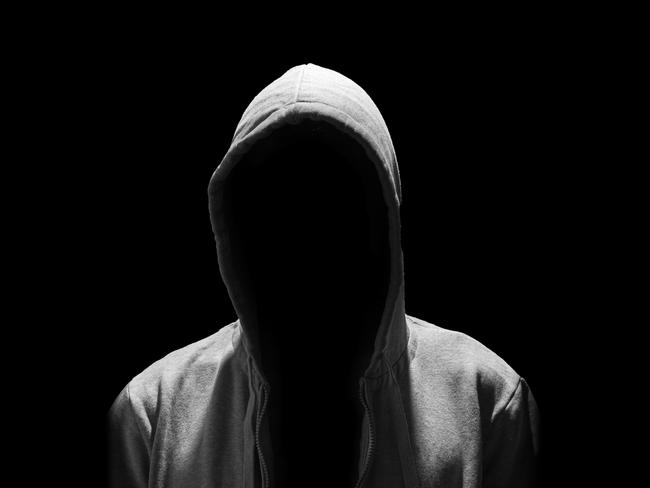 Portrait of Invisible man in the hood isolated on black background creep pervert molestor generic Photo: iStock