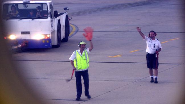 Ansett ground staff at Melbourne Airport wave off the last flight to Adelaide with a giant novelty hand in 2002.