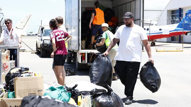 Jacob Matysek unloads supplies from a truck to be loaded onto a Daintree Air Services light plane flying essential items to flood victims in Cooktown. Ms Parker helped coordinate the collection of water, food, clothing and sanitary products to be flown north, after record flooding caused by ex Tropical Cyclone Jasper. Picture: Brendan Radke