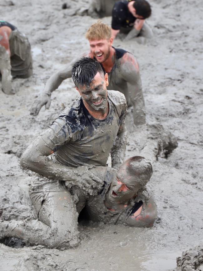 Trent Cotchin and Dusty Martin take part in the mud-filled obstacle course. Picture: Molly Stapleton/Richmond FC