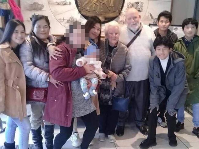 From left: Flordeliza Dolar, 19, Divine Dolar, 56, name withheld, Mika Clariman (baby), Diseree Brown, Paul Brown's mum, Paul Brown, Mark Lagud (front, blue jacket), Pedro Clariman (back), Luie Lagud (right, green jacket).