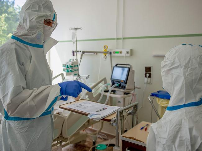 Doctors wearing personal protective equipment (PPE) as they treat a patient infected with the novel coronavirus. Picture: AFP