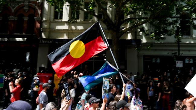 Australia’s Aboriginal flag flies during a march in Melbourne.