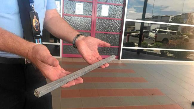 DEADLY: Darling Downs City Patrol Group Acting Inspector Matt Howard with one of the 50cm metal poles found near the incident scene where a Laidley Heights woman, 60, was impaled while driving west on the Warrego Highway near Oakey. Picture: Tara Miko