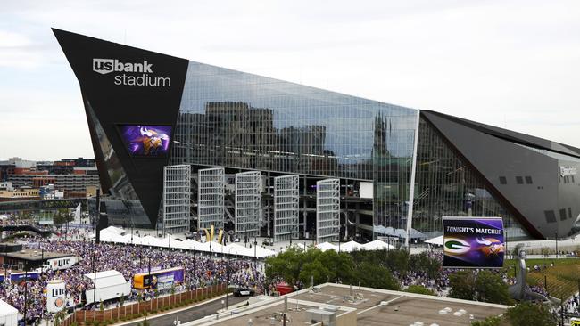 Fans arrive at U.S. Bank Stadium before an NFL football game between the Minnesota Vikings and the Green Bay Packers.