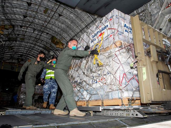 Members of the Australian military unload supplies in Tonga. Picture: AFP