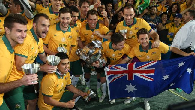 Australian players celebrate with their national flag.