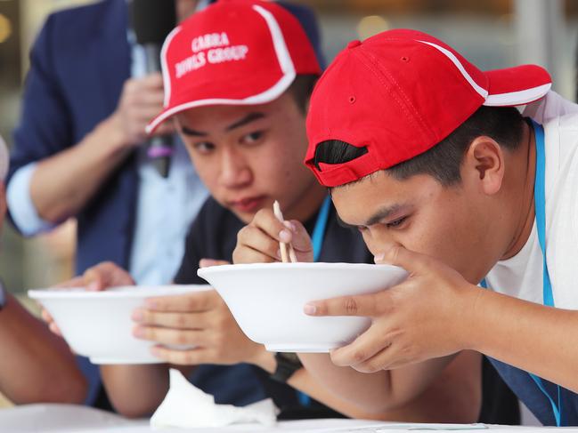 Ricky Tran and Long Kieu competing in the noodle eating competition at the Moon Festival, in September, 2017. Picture: Carmela Roche.