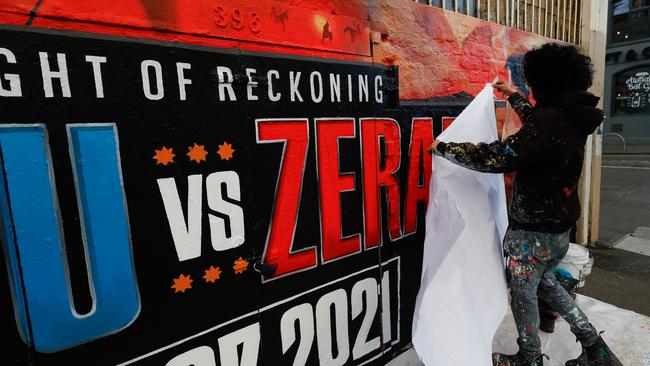 Painters replace Michael Zerafa on the mural to promote the fight. Picture: Getty Images