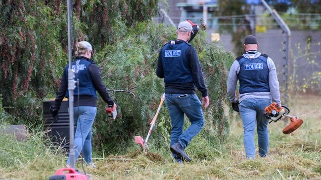 Police search through trees for more evidence. Picture: Brenton Edwards