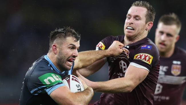 James Tedesco (left) fends off Queensland defender Michael Morgan during game two in Perth. Picture: Brett Costello