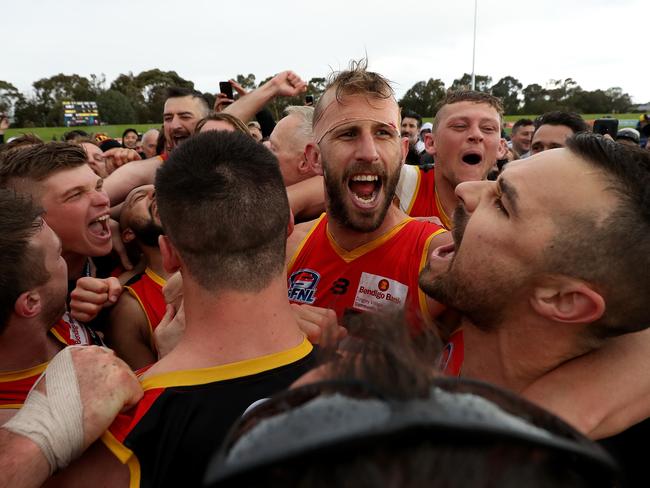 The Dingoes celebrate after the final siren.