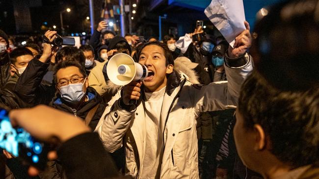 A demonstrator holds a blank sign and chants slogans during a protest in Beijing on Monday. Source: Bloomberg