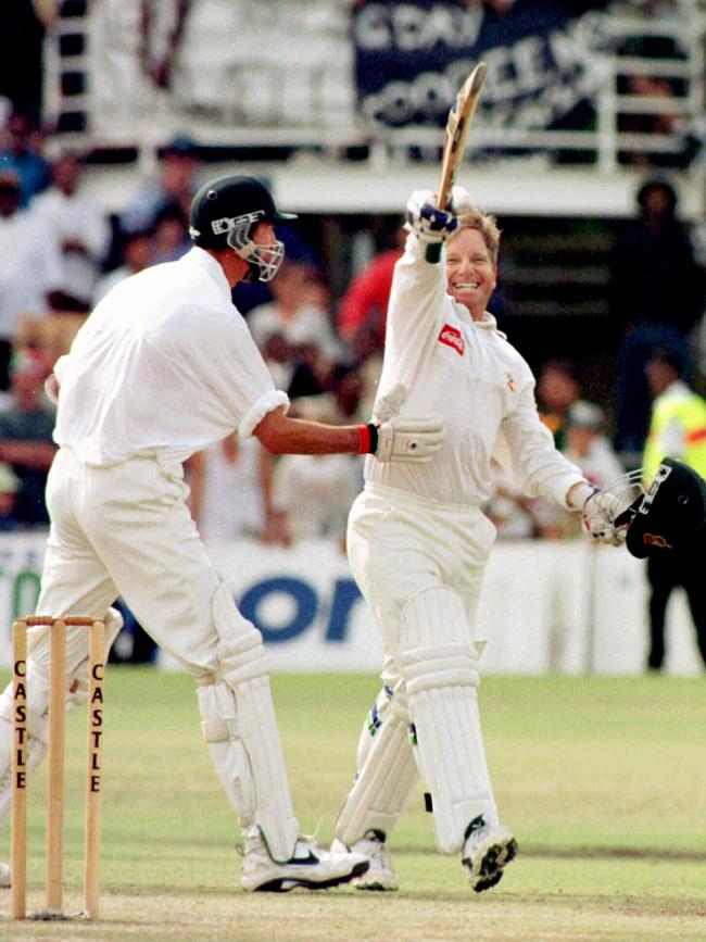 Ian Healy raises his bat victoriously after hitting the match winning six.