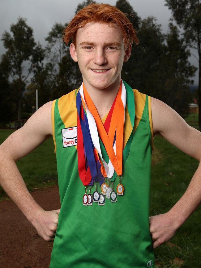 Bayswater footballer Ben White with his swag of junior best and fairest awards. Picture: Hamish Blair