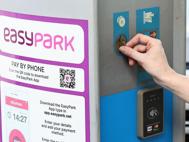 A Cairns city office worker pays for her on street cae park in the CBD at a Cairns Regional Council parking meter. Picture: Brendan Radke