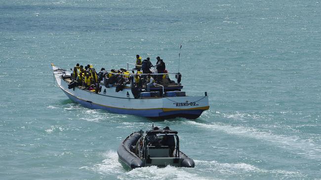 A Royal Australian Navy boat escorts a vessel the boat containing 40-50 asylum seekers.