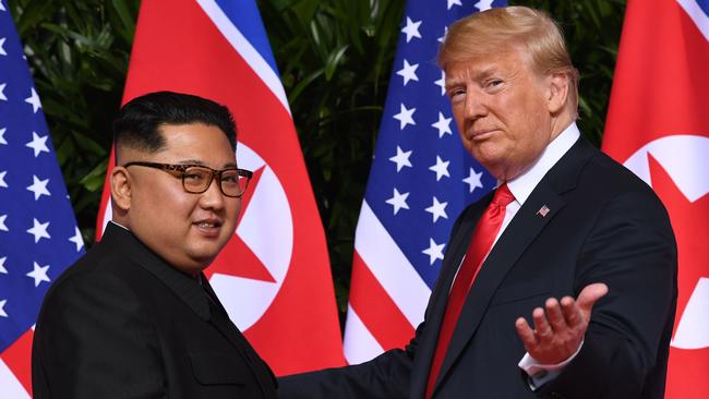 AFP presents a retrospective photo package of 60 pictures marking the 4-year presidency of President Trump.  US President Donald Trump (R) gestures as he meets with North Korea's leader Kim Jong Un (L) at the start of their historic US-North Korea summit, at the Capella Hotel on Sentosa island in Singapore on June 12, 2018. - Donald Trump and Kim Jong Un have become on June 12 the first sitting US and North Korean leaders to meet, shake hands and negotiate to end a decades-old nuclear stand-off. (Photo by SAUL LOEB / AFP)