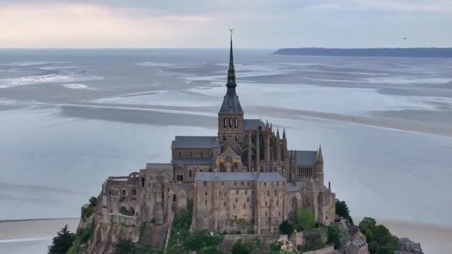 Olympic torch arrives at the iconic Mont-Saint-Michel Abbey