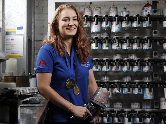 Apprentice spray painter Isabella Turrise at work at Kingswood Smash Repairs. Picture: Jonathan Ng