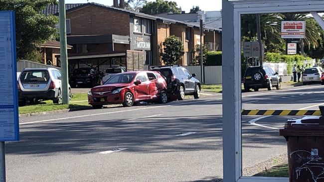 The red car residents say was hit by the bus, as well as multiple vehicles after it hit and killed a woman and her dog at Adamstown. Picture: Amy Ziniak