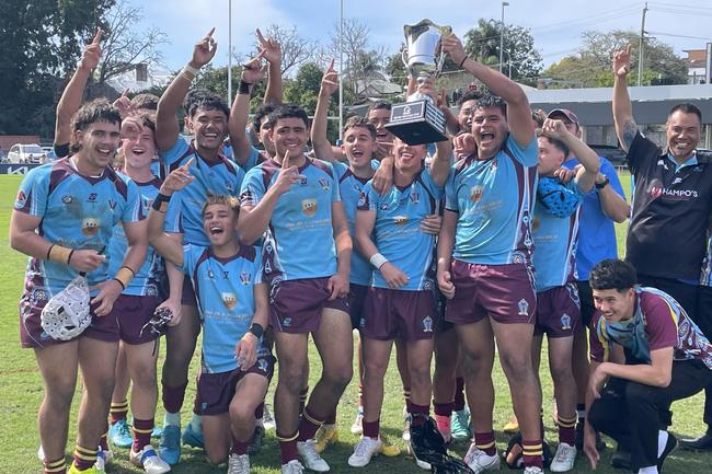 Keebra Park SHS celebrate the Walters Cup premiership. Buried in the heaving throng of jubilation is Harvey Smith (middle, left hand on the trophy with white strapping on his right wrist).