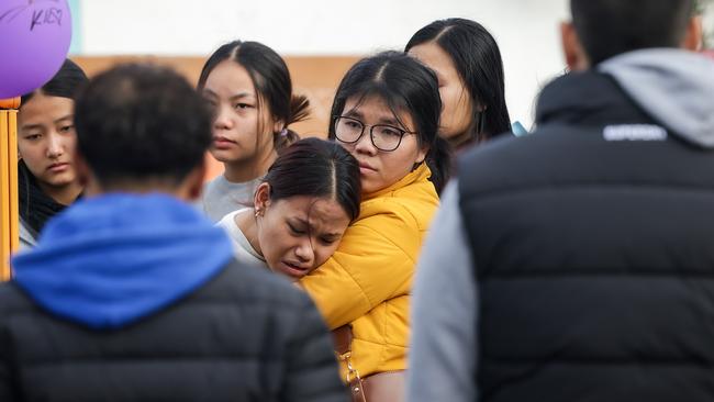 Mourners gather at the bus stop in Sunshine where 16yr old Pasawm Lyhym was stabbed to death by youths during the week. Picture: Ian Currie