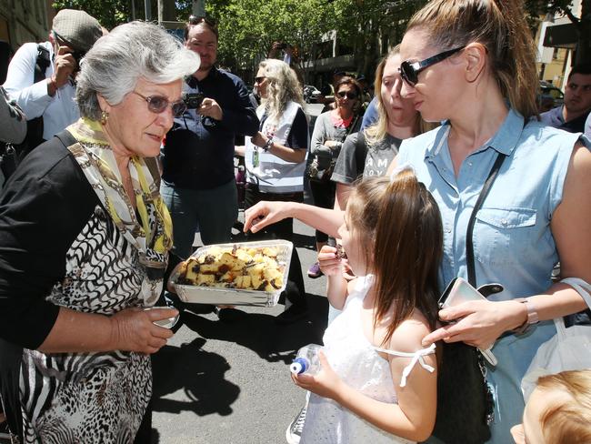 Long-time worker Lucia hands out Sisto’s favourite chocolate and almond cake. Picture: Michael Klein