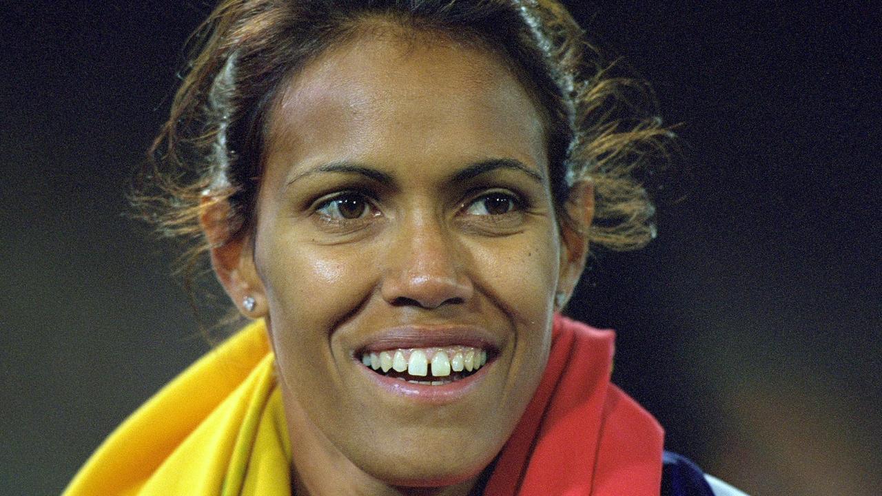 Cathy Freeman of Australia celebrates winning gold in 2000.