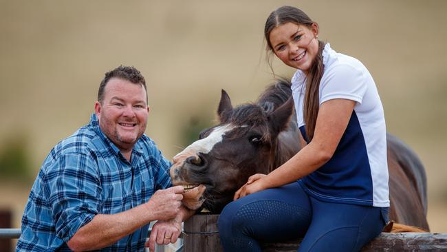 Andrew ‘Cosi’ Costello with his daughter Matilda and horses Molly and Winnie, on his farm at Harrogate. Picture: Matt Turner