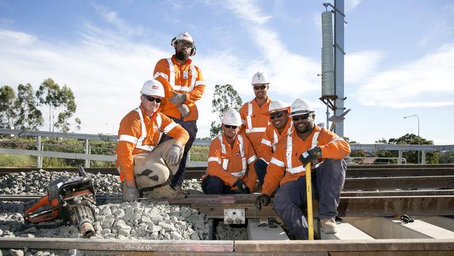 Sydney Metro construction workers completing the final tracklaying at Bella Vista Station.