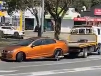 The Holden Commodore being taken away by a tow truck. Picture: Dennis Taunoa