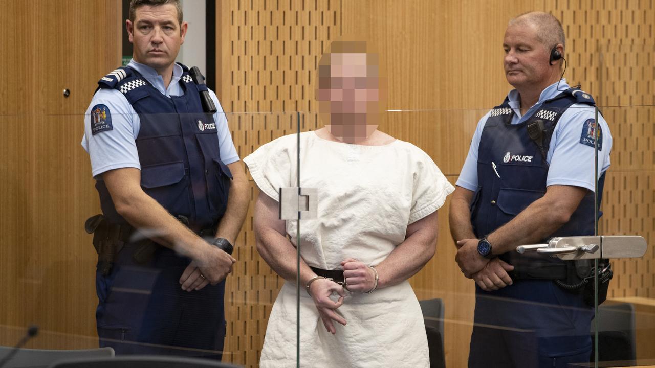 The man charged in relation to the Christchurch massacre, Brenton Tarrant, gestures as he is lead into the dock for his court appearance. Picture: Mark Mitchell-Pool