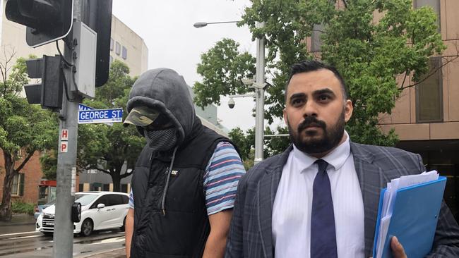 Granville man Kevin Jones (left) leaves court with his lawyer Javid Faiz.