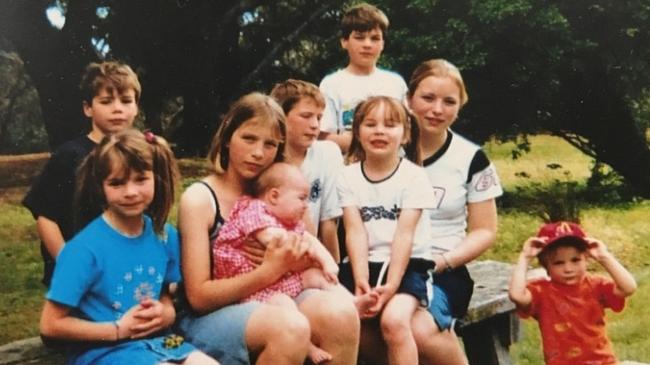 James and his siblings: From left, Thomas, Sarah, Kate, Jacque (baby), Matt, Emily, Christine. Brother Aaron is at the back right and James at the front right. Picture: Supplied