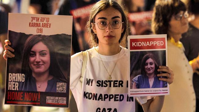 A woman holds placards identifying one of the Israeli hostages held by Palestinian militants. Picture: AFP