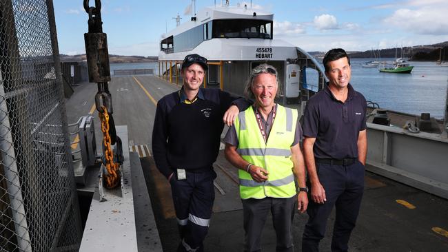 L-R deck hand Tom Malone, engineer Andree Schepers, ferry master Craig Pfennigwerth on the loading ramp with the new ferry. New Bruny Island ferry Nairana is now in operation linking Kettering and Bruny Island. Picture: NIKKI DAVIS-JONES