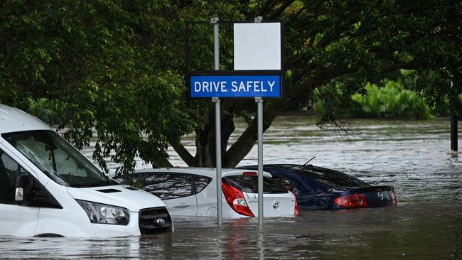 1/122024: Flash flooding in Hanlon Park , rapidly flooded around 10 cars, as police and fire and rescue check the cars are empty, Stones Corner, Brisbane. pic: Lyndon Mechielsen/Courier Mail