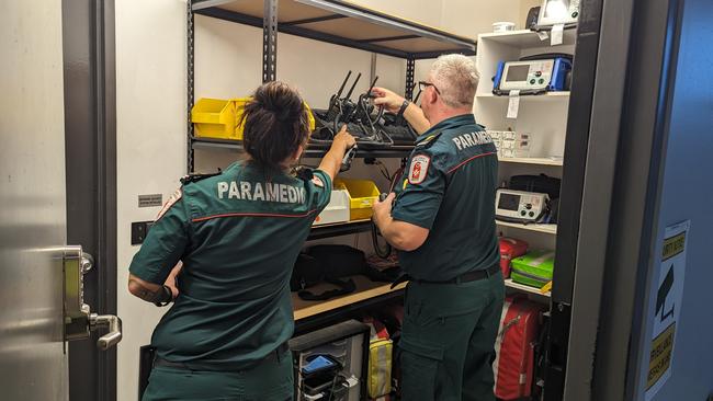 St John Ambulance NT director of ambulance services Andrew Thomas and duty officer Sam Cooper equipping themselves for a busy Friday night shift. Picture: Alex Treacy